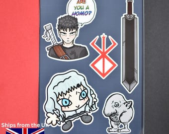 May include: A sticker sheet featuring anime-style illustrations. The sheet includes a character with a sword, a large sword, a character with a speech bubble that says "ARE YOU A HOMO?", a symbol, and a small creature.