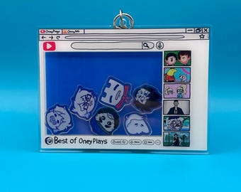 May include: A clear acrylic keychain featuring a YouTube-style interface with the text "Best of OneyPlays." The design includes cartoon character illustrations and a blue background, with a silver-colored metal ring at the top.