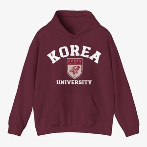 May include: A maroon hoodie with a white "KOREA UNIVERSITY" logo and a crest featuring a tiger.