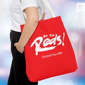 May include: A handmade wooden serving tray with a natural finish. The rectangular tray has rounded corners and two carved handles. The visible wood grain adds to its rustic charm. Dimensions: 40.6 cm long, 25.4 cm wide, and 5.1 cm high.