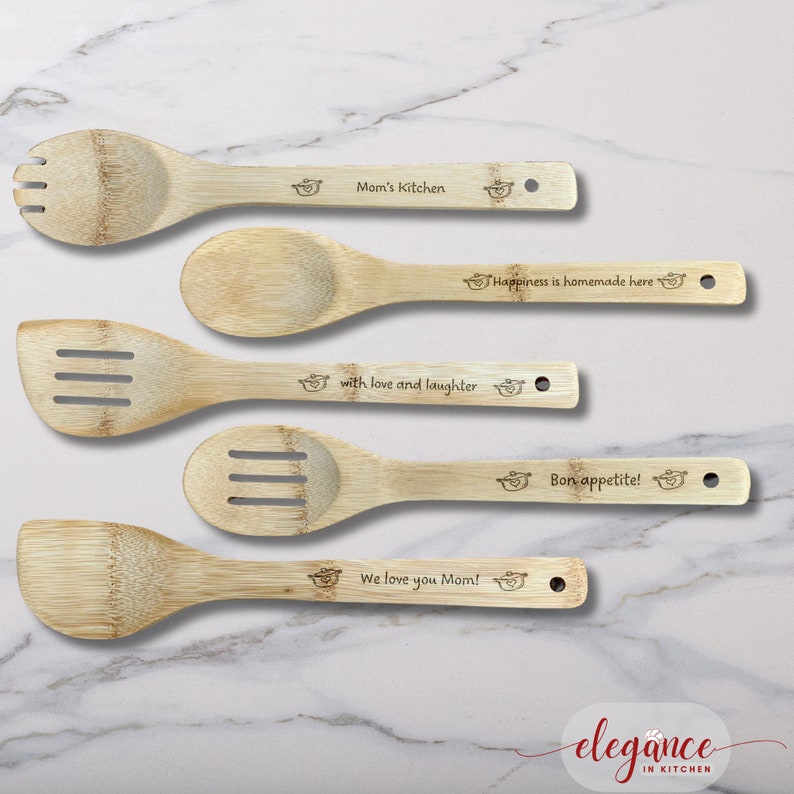 four wooden spoons with engraved names on them