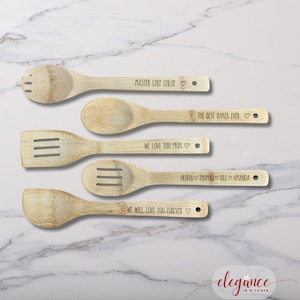 a set of four wooden spoons on a marble surface