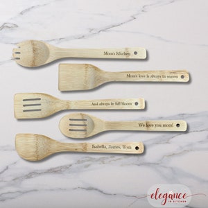 a set of four wooden utensils with engraved names