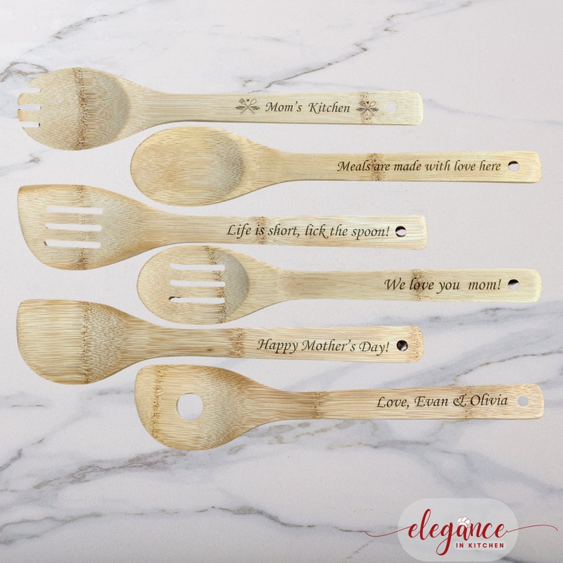 a set of four wooden spoons on a marble surface