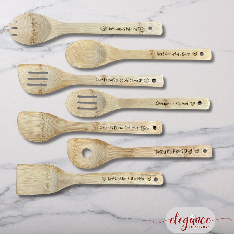 a set of four wooden utensils on a marble counter