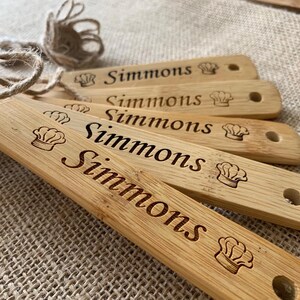 three wooden tags with words on them sitting on a table