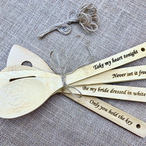four wooden spoons with engraved words on them