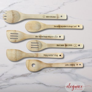 four wooden spoons with engraved names on them