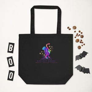 May include: Black tote bag with a colorful cat illustration and the text "Magicat Books" with the tagline "Books | Coffee | Spells".