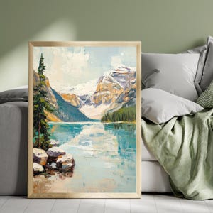May include: A framed painting of a mountain lake scene with a tall evergreen tree in the foreground. The lake is a bright blue and reflects the snow-capped mountains in the background. The sky is a light blue with white clouds.