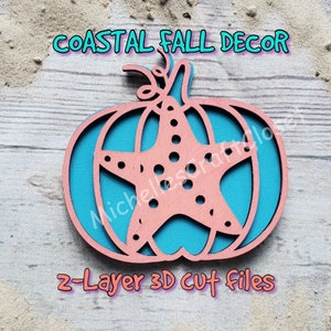May include: A two-layer 3D cut file design of a pink pumpkin with a blue starfish inside. The text "COASTAL FALL DECOR" is at the top of the image and the text "2-Layer 3D Cut Files" is at the bottom of the image.