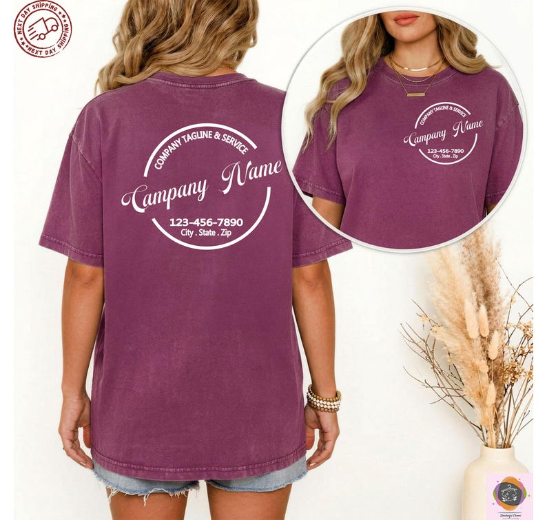 May include: A maroon t-shirt with a white circular design on the back that reads "Company Name", "Company Tagline & Service", and a phone number and address. A smaller version of the design is on the front. The shirt is short-sleeved.