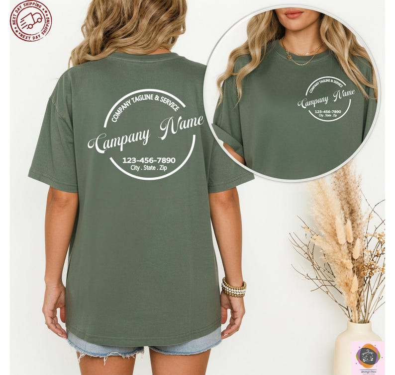 May include: Olive green t-shirt with a circular logo on the back that reads "Company Name" and includes a phone number and address. The shirt has short sleeves and a crew neck. The same logo is on the front of the shirt.