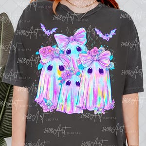 a t-shirt with a graphic design of four colorful, ghostly figures with bows and flowers.