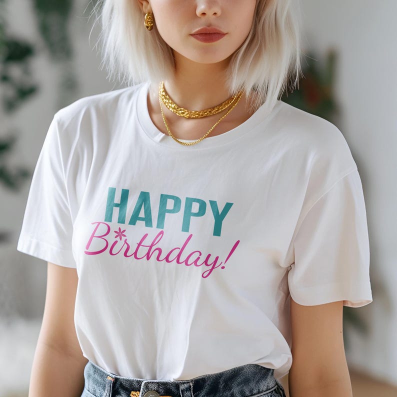 May include: White t-shirt with the text "HAPPY Birthday!" printed in teal and pink.