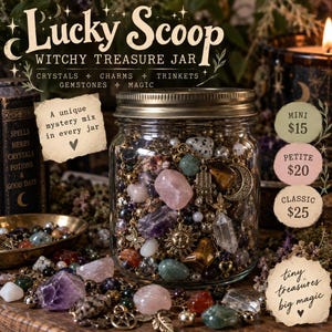 May include: A clear glass jar filled with a variety of crystals, gemstones, and metal charms including a sun, moon, and hamsa. The jar features a metal lid and text that reads Lucky Scoop Witchy Treasure Jar, A unique mystery mix in every jar, and tiny treasures big magic.