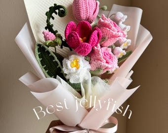 May include: A bouquet of crocheted flowers in pink, white, and green, wrapped in white tissue paper and tied with a pink ribbon. The bouquet is labeled "Best Jellyfish".