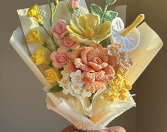 May include: A crocheted bouquet of flowers in shades of yellow, pink, and white. The flowers are wrapped in a white paper with a lace trim and tied with a pink ribbon. The text "Best Jellyfish" is visible at the bottom of the image.