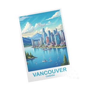 May include: A jigsaw puzzle featuring a scenic illustration of Vancouver, Canada. The artwork depicts a cityscape with tall buildings, a body of water with sailboats, and a mountain range under a blue sky with clouds. The text "VANCOUVER CANADA" is printed at the bottom.