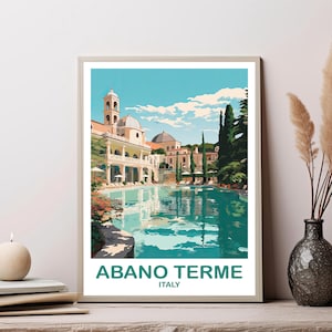 May include: A framed art print featuring a vintage travel poster for Abano Terme, Italy. The artwork depicts a large pool reflecting a building with a domed roof and a clear blue sky. The text "ABANO TERME ITALY" is at the bottom.