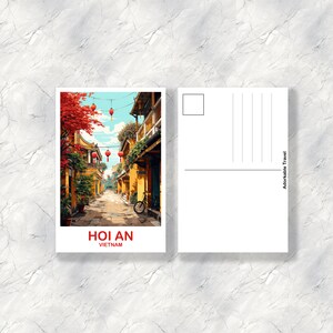 May include: A postcard featuring a colorful illustration of a street in Hoi An, Vietnam. The street is lined with yellow buildings and red lanterns. A bicycle is parked on the side of the street.