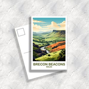 May include: A postcard depicting a stylized landscape of the Brecon Beacons in Wales. The image shows a river flowing through green valleys and orange hills under a blue sky with clouds. The text "BRECON BEACONS WALES" is at the bottom.