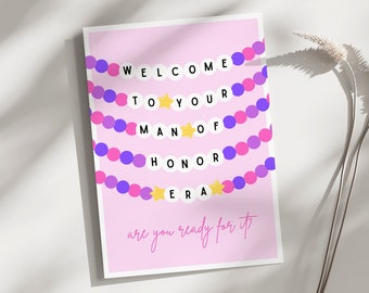May include: A pink card with the text "WELCOME TO YOUR MAN OF HONOR ERA are you ready for it?" in a white circle garland with purple and pink beads and gold stars.