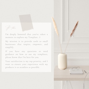 May include: A white card with a message about providing tools for small businesses. The card is on a wooden table with a white vase containing dried pampas grass and a pair of glasses.