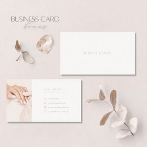 May include: A business card design with a minimalist style. The card displays the text "SHEILA JONES" and "NAIL ARTIST" along with contact details. The design includes a hand with manicured nails, and decorative dried leaves. The colour scheme is neutral.