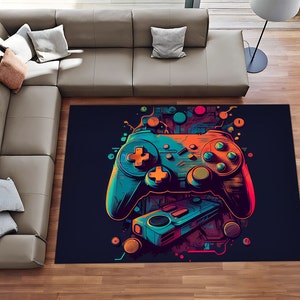 Peut inclure: Un tapis coloré avec un motif graphique d'une manette de jeu vidéo. La manette est bleue, orange et verte sur un fond noir. Le tapis est parfait pour ajouter une touche de couleur à n'importe quelle pièce.