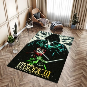 May include: A rectangular Star Wars Episode III: Revenge of the Sith rug. The rug has a black background with a graphic of characters with lightsabers. The rug is placed on a wooden floor.