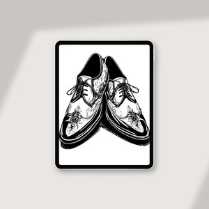 May include: A pair of black leather shoes with intricate floral designs. The shoes have lace-up closures and a pointed toe.