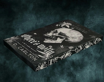 May include: A black book with the title "Where's My Will?" and the author's name "L.D. Carlton" printed on the cover. The cover features a skull with a floral design.