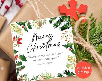 May include: A square gift tag with the words "Merry Christmas" in elegant script, surrounded by watercolor illustrations of holly, berries, and pine branches. The tag includes a quote by Thomas S. Monson and is tied with twine.