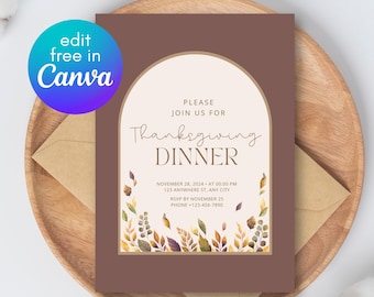 May include: Thanksgiving dinner invitation card with a brown border and an arch design. The invitation includes the text "Thanksgiving Dinner" and event details. The card is decorated with fall foliage and is on a wooden plate with an envelope.