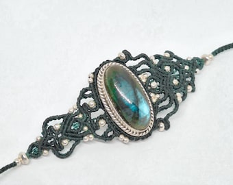 Silver bracelet with Labradorite stone woven with dark green thread. Exclusive piece of jewelry.