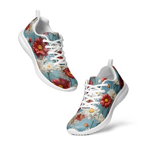 May include: A pair of white sneakers with a floral print. The print features red, white, and yellow flowers on a blue background.