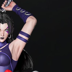 May include: A purple and silver action figure of a female character with long black hair, wearing a purple bodysuit with red and silver accents, holding a silver sword. The figure is posed in a dynamic fighting stance, with one leg raised and the other bent. The figure is standing on a gray rock base.