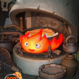 May include: A red and orange fire spirit with a smiling face sits on a stone base with a pan of bacon and eggs on top. There are two small wooden figures on either side of the spirit. The spirit is a popular character from the animated film "Howl's Moving Castle".