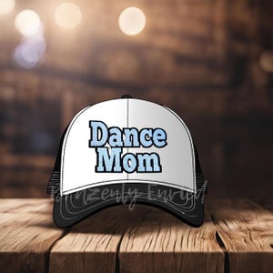 May include: A black and white trucker hat with a white front panel and a black mesh back. The front panel has the text "Dance Mom" in blue and white lettering.