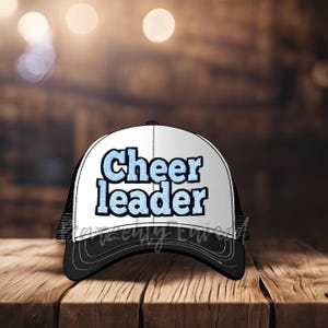 May include: A black and white trucker hat with a blue and white "Cheerleader" patch on the front.