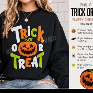 May include: A black sweatshirt featuring a large, textured chenille patch with the text TRICK OR TREAT in white, orange, and lime green. The design includes a central orange jack-o'-lantern pumpkin graphic with a green stem and black facial features.