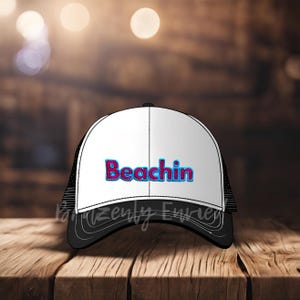 May include: A black and white trucker hat with a white front panel and a black mesh back. The front panel has the word "Beachin" in pink and blue letters.