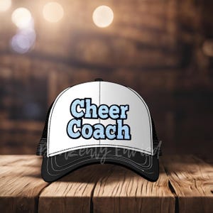May include: A black and white trucker hat with a blue and white 'Cheer Coach' text on the front.