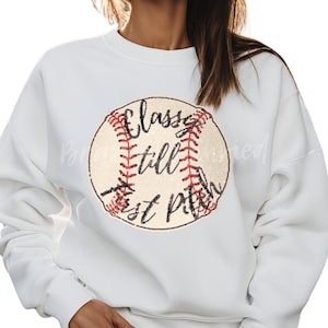 May include: White sweatshirt with a baseball graphic and the text "Classy till the last pitch".