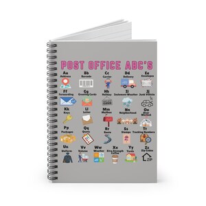 May include: A gray spiral notebook with a pink title "POST OFFICE ABC'S" and a grid of 26 illustrated icons representing postal terms and their corresponding letters of the alphabet. Each icon is labeled with a letter and a word, such as "Aa Address", "Bb Barcode", "Cc Carrier", and so on.