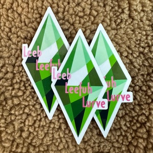 May include: Three green and white diamond-shaped stickers with the words "Leefuh" and "Lurve" printed in pink.