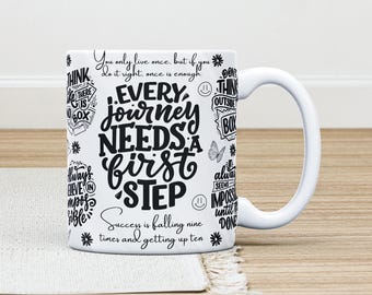 May include: White ceramic mug with a black inspirational quote that reads "Every journey needs a first step. Success is falling nine times and getting up ten." The quote is surrounded by other inspirational phrases.