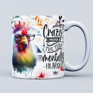 May include: White ceramic mug featuring a colourful illustration of a rooster wearing glasses and floral designs. The mug has black text that reads "Crazy I prefer the term mentally hilarious".