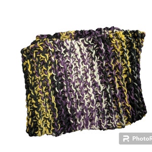May include: A knitted scarf with stripes of black, purple, white and yellow yarn.